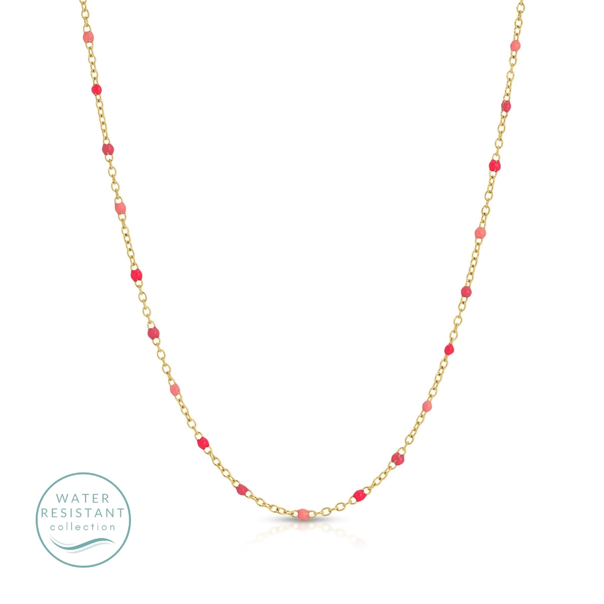 Gold chain necklace with red beads on a white background