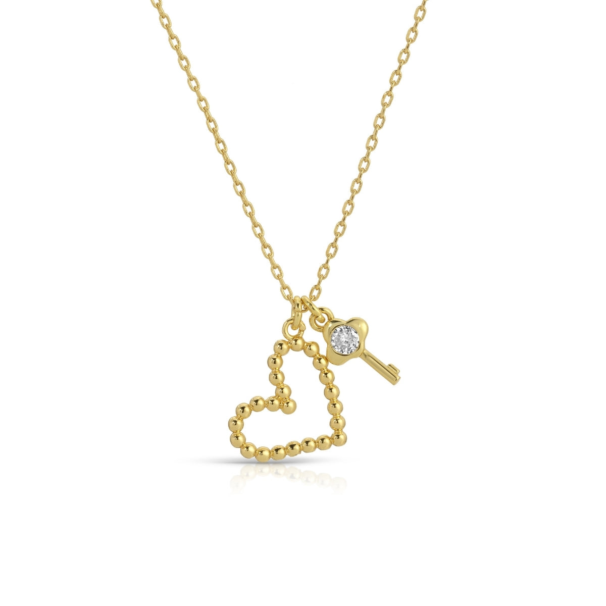Gold necklace with heart and key pendant on a white background