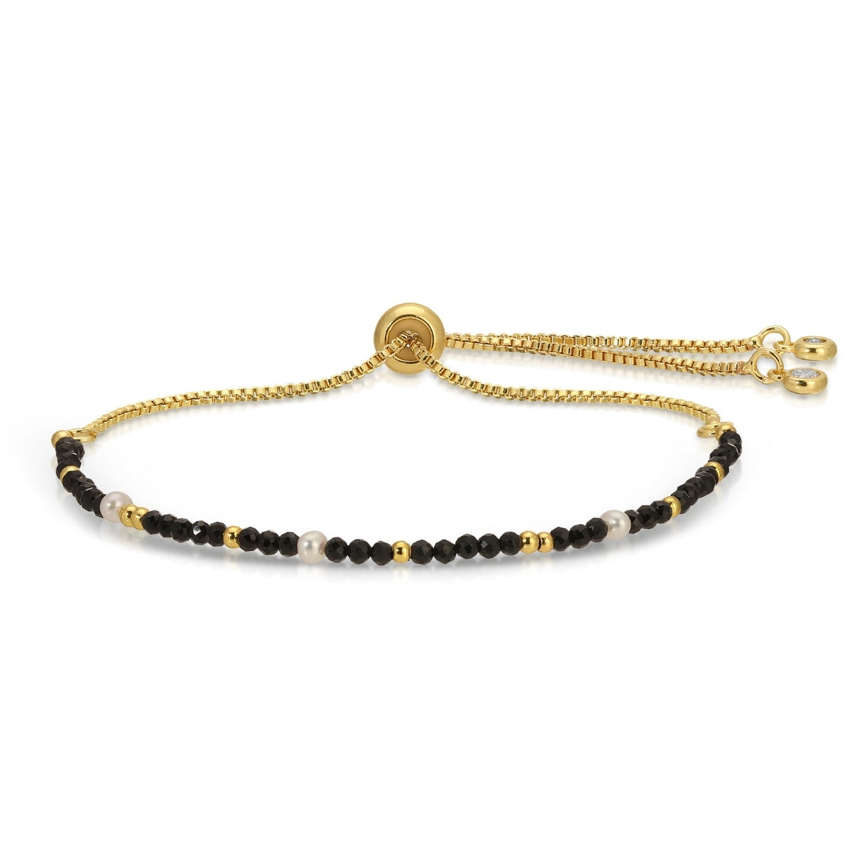Gold bracelet with black and white beads on a white background