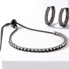 Flat Lay photograph of gunmetal faux diamond pulley bracelet and faux diamond gunmetal earrings